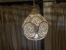 Charming pendant light with intricate brass details, ideal for creating a cozy atmosphere.