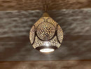 Elegant handmade Moroccan brass pendant light casting intricate shadows on the ceiling.