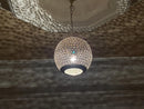 Close-up view of the handcrafted Moroccan brass pendant light highlighting its detailed craftsmanship.